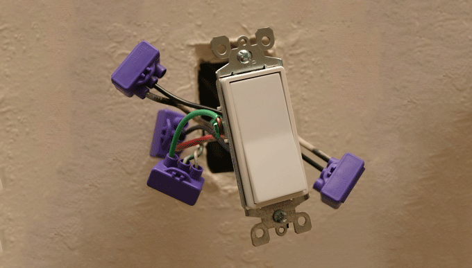 A man is working on a roof with solar panels.