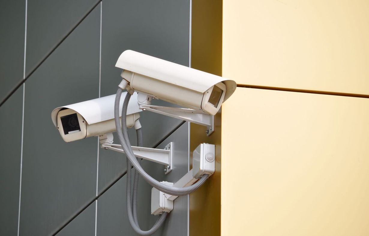 A security camera mounted on the side of a house