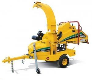 Yellow Vermeer wood chipper on wheels, ready to process wood.
