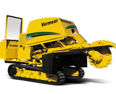 Yellow Vermeer stump grinder on tracks, grinding.