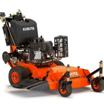 Orange Kubota stand-on mower with black engine, a grass catcher, and front wheels on a white background.
