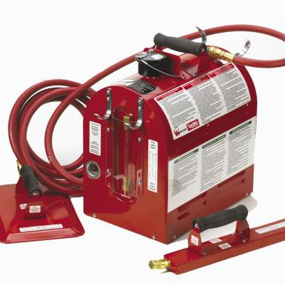 Red carpet cleaning machine with a hose and attachments.
