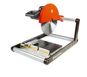 Husqvarna tile saw, orange and silver, with a circular blade and black base, for cutting tiles.