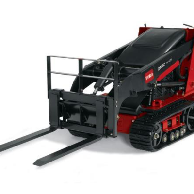 Red and black Toro compact track loader with forklift attachment.