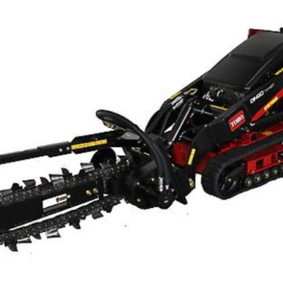 Black and red Toro trencher on tracks; digging tool on the end.