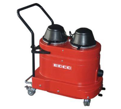 Red EDCO industrial vacuum with black tops and handle, on a rolling cart.