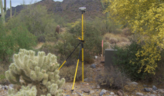 A tripod is sitting in the middle of a desert.