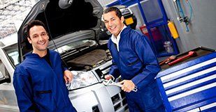 mechanics working on a car