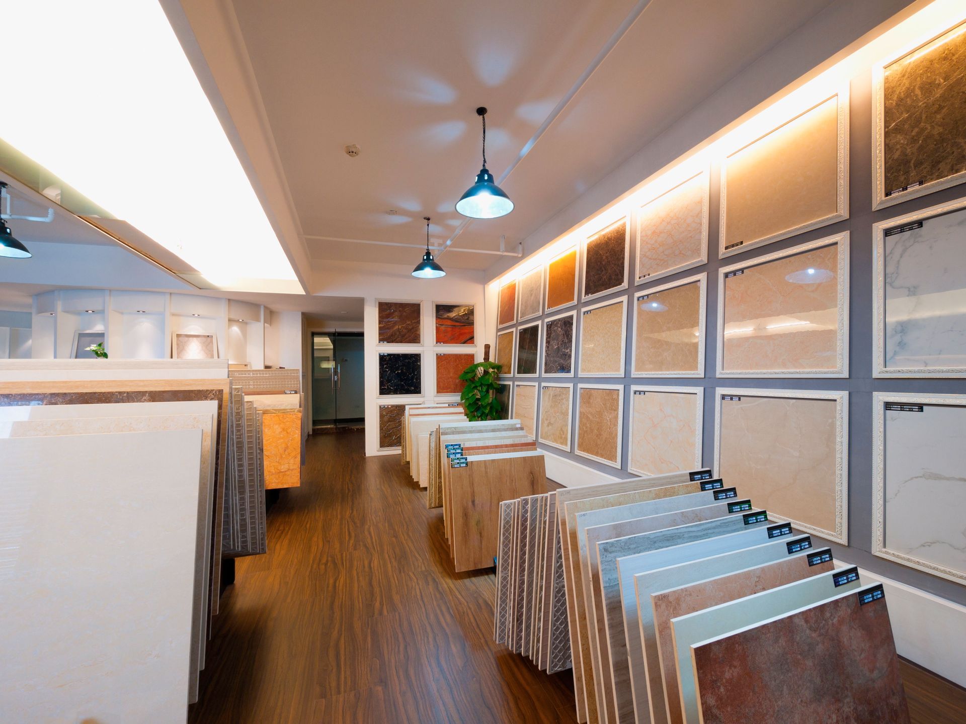 Display of various wood flooring samples in different colors and finishes, arranged on shelves.