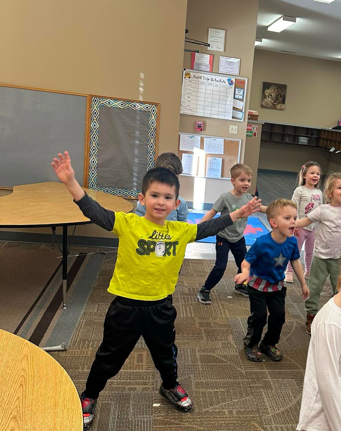 A group of children are dancing together in a room.