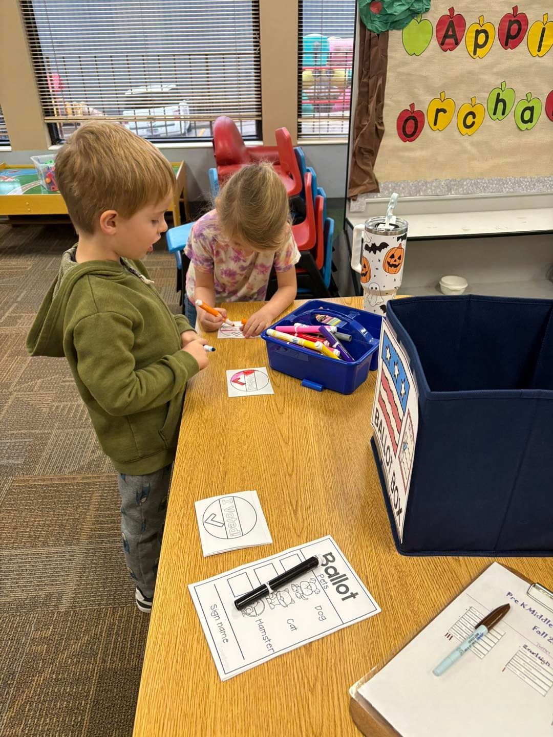 A boy and a girl are writing on a paper.