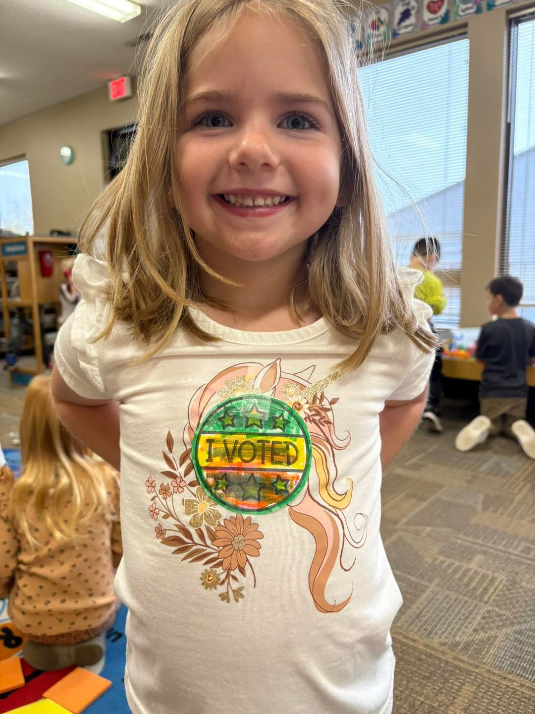 A little girl is wearing a t-shirt.