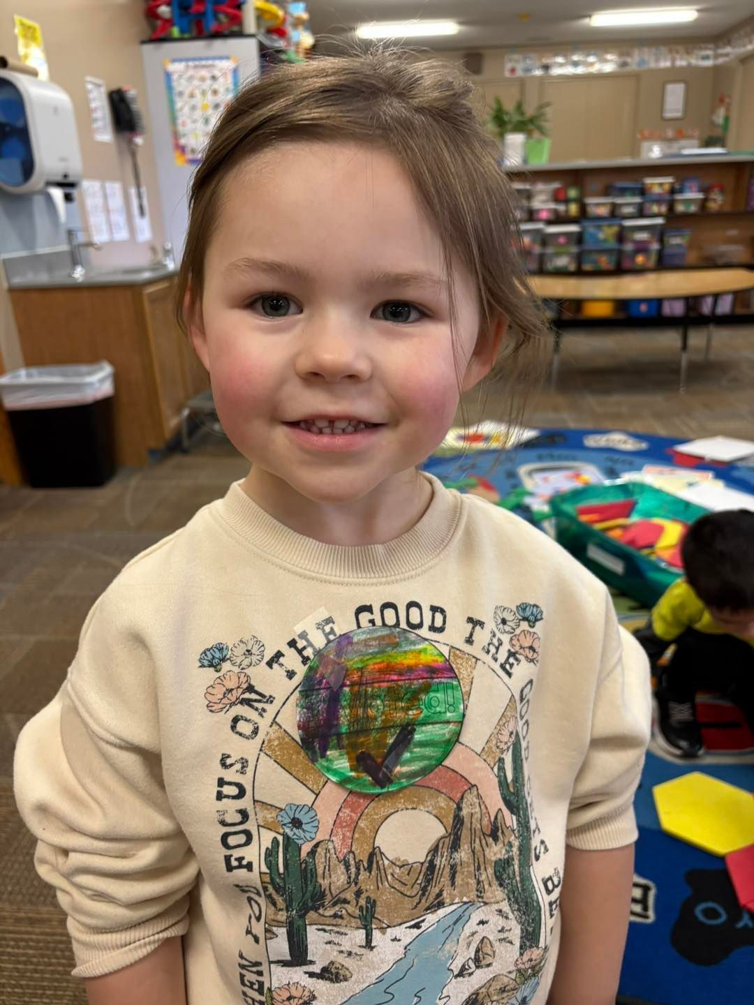 A little girl wearing a sweatshirt