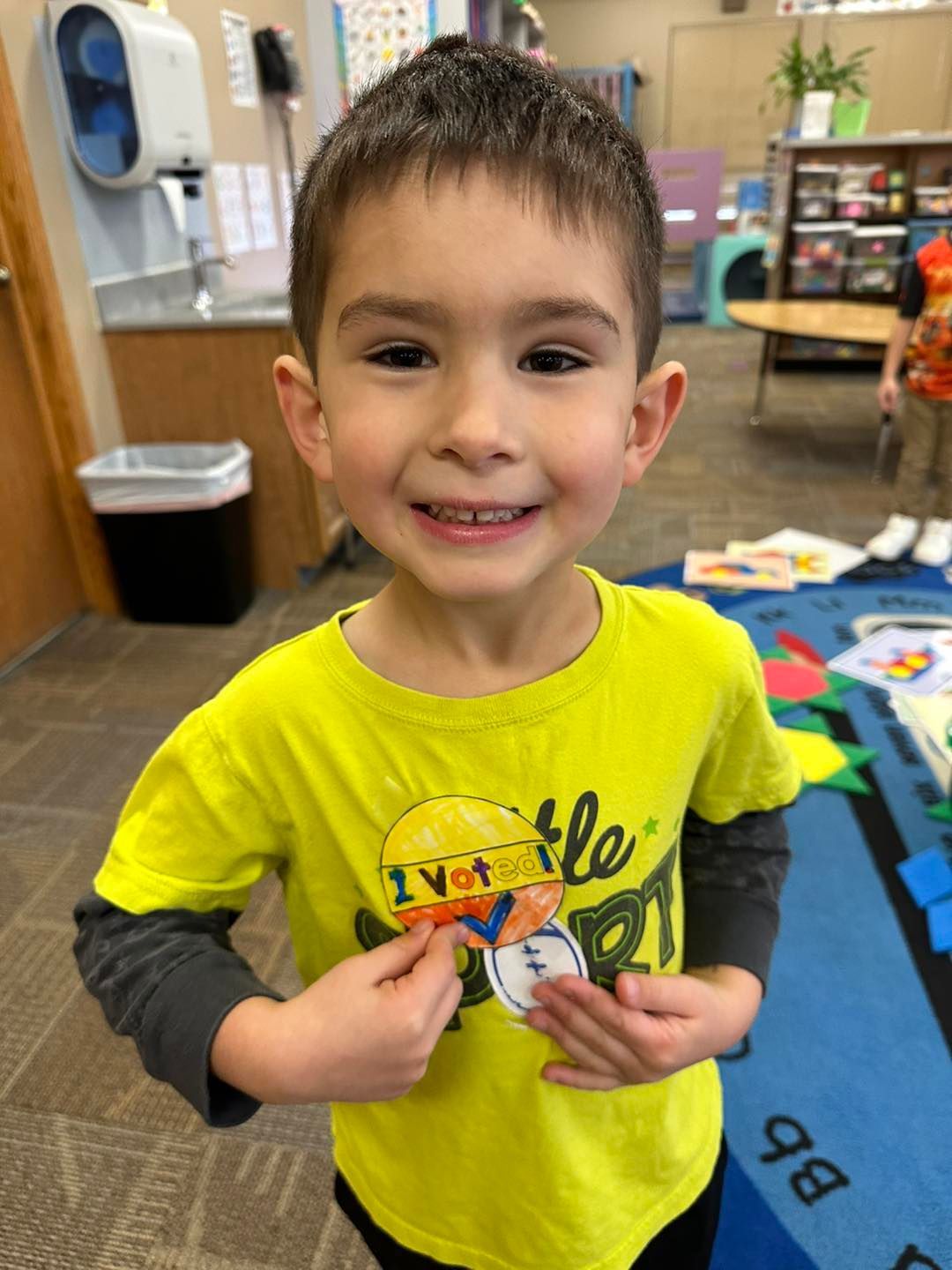A young boy wearing a yellow shirt