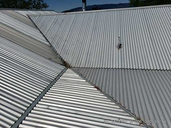 Close-up of a corrugated metal roof with multiple angled panels.