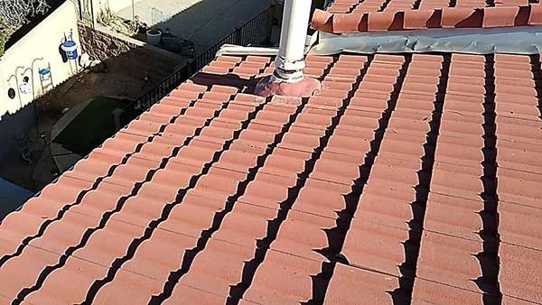 Red tiled roof with a chimney, viewed from above.