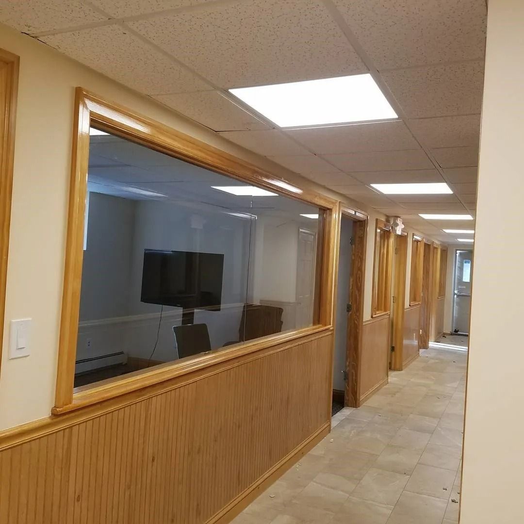 A hallway with a lot of windows and wood paneling