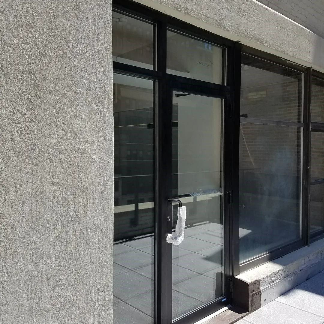 A building with a black door and a lot of windows