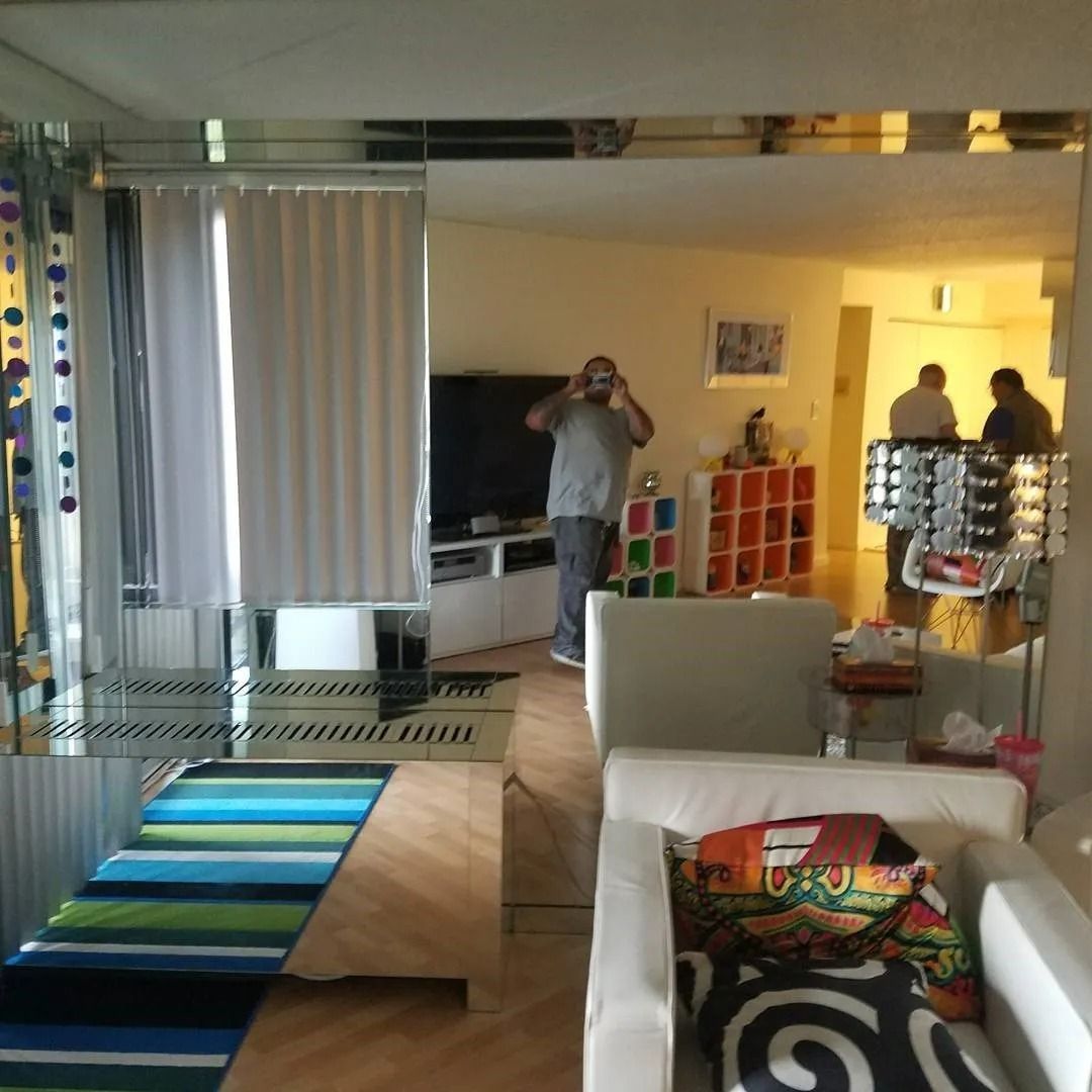 A man taking a picture of himself in a living room