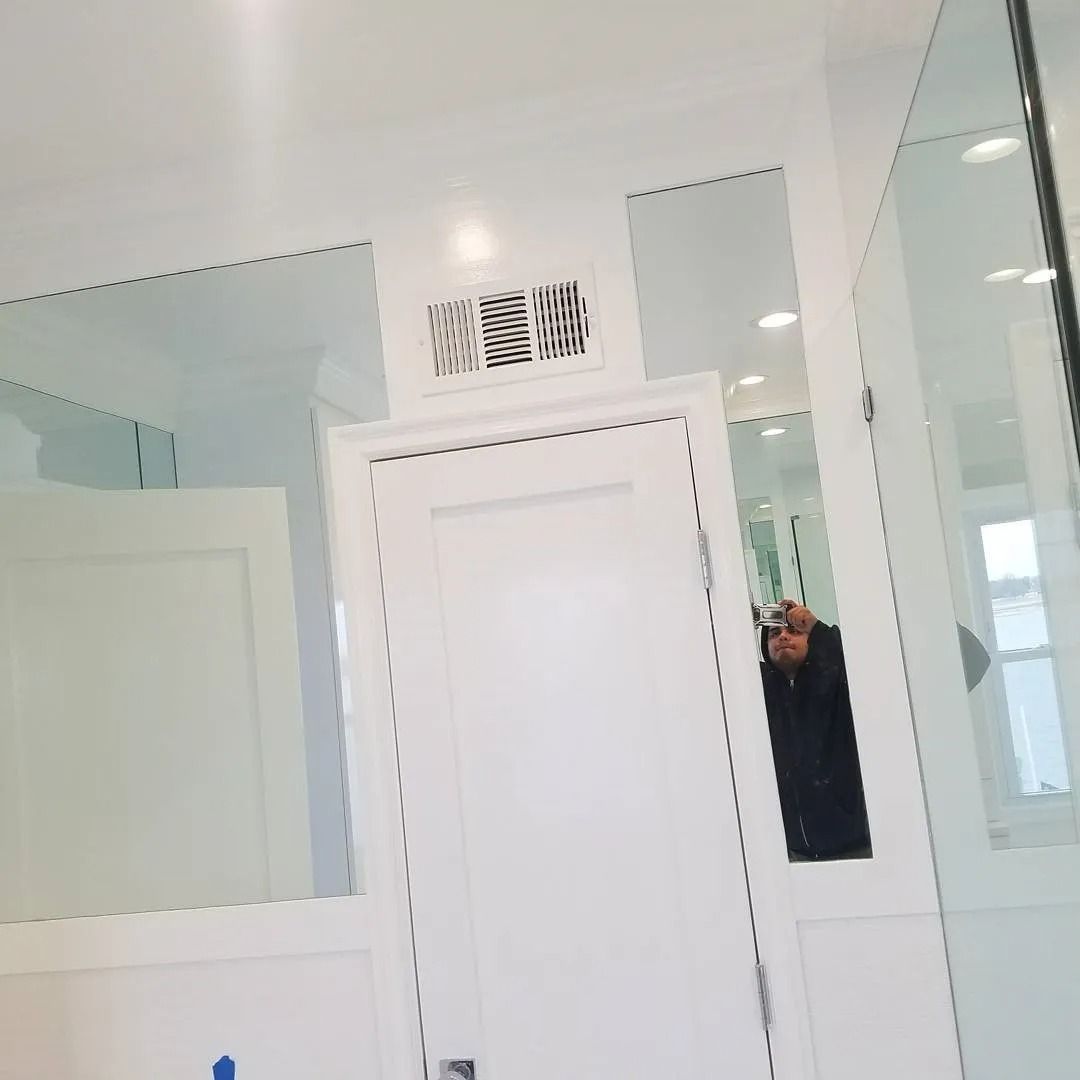 A person is taking a picture of themselves in a bathroom mirror.