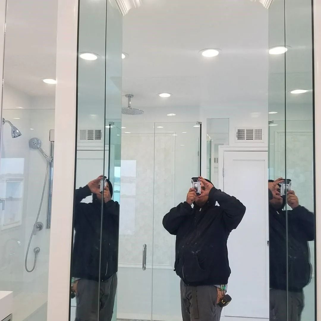 A man is taking a picture of himself in a bathroom mirror