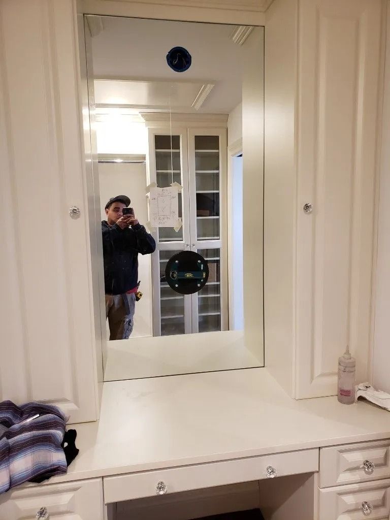 A man is taking a picture of himself in a mirror in a bathroom.