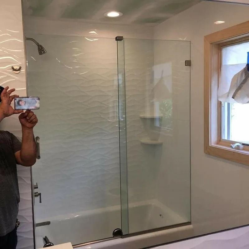 A man is taking a picture of himself in a bathroom mirror.