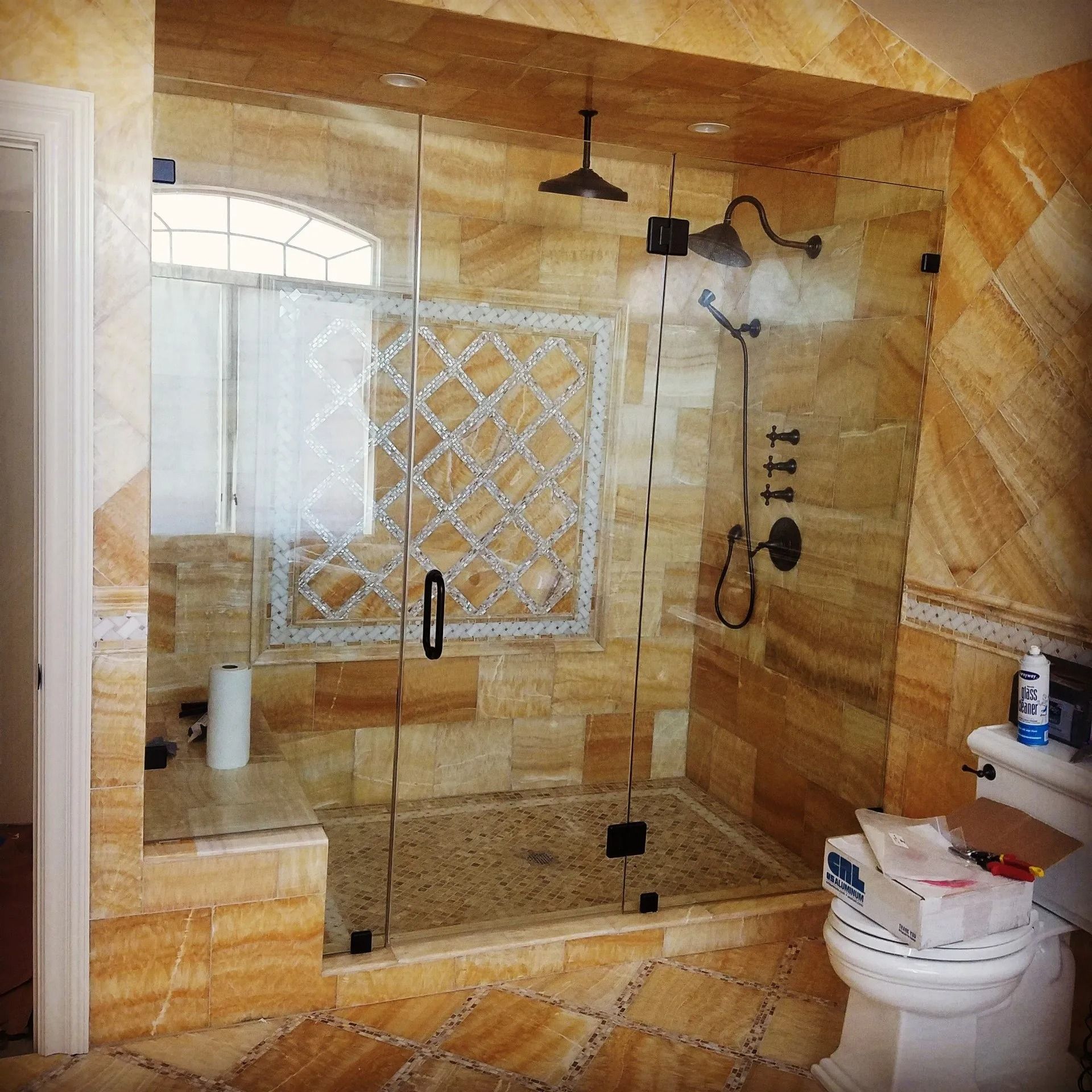 A bathroom with a walk in shower and a toilet