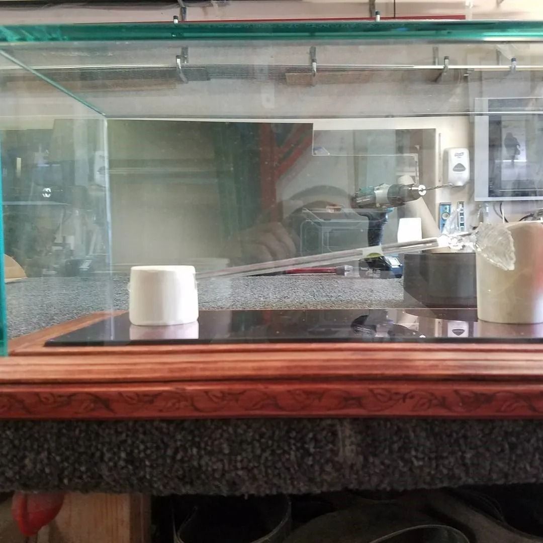 A glass aquarium is sitting on top of a wooden table.
