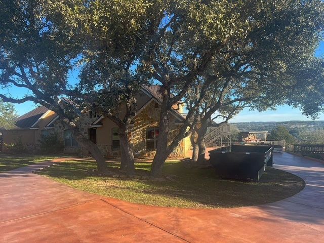 A house with a lot of trees in front of it