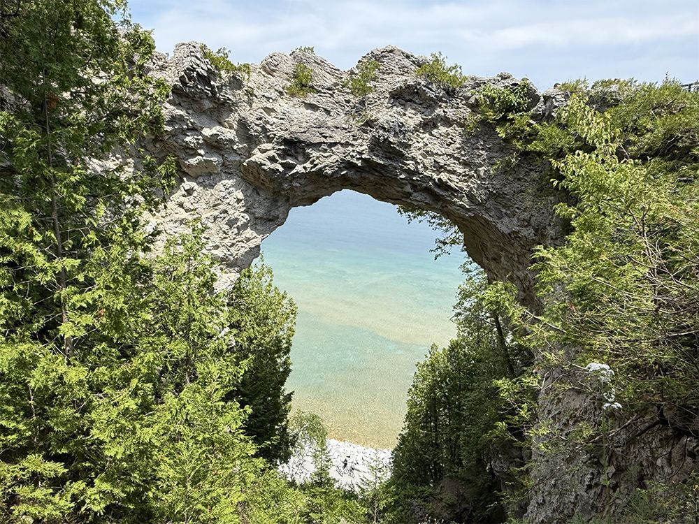 Arch Rock on Mackinac Island, Michigan, with turquoise water visible through the opening.