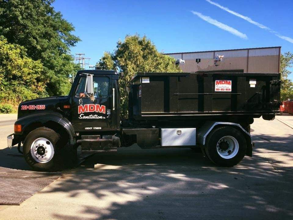MDM Sanitation Inc black truck