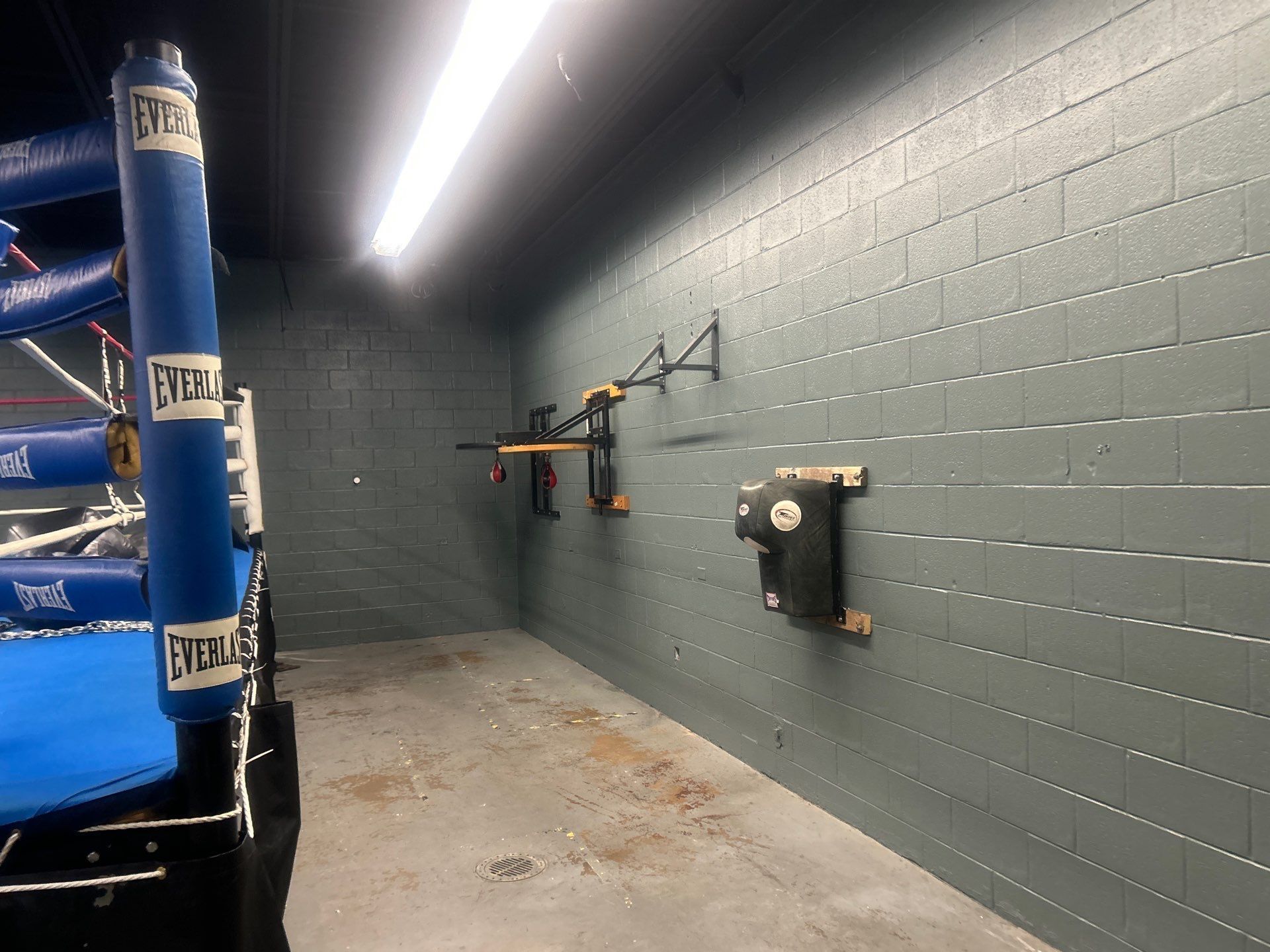 Empty boxing gym wall with mounted equipment