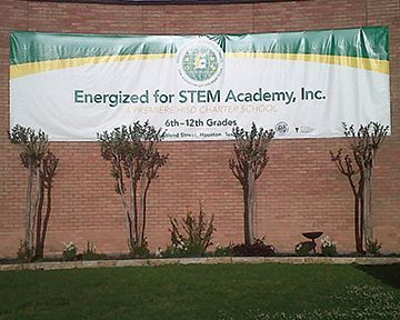 A banner on a brick wall that says energized for stem academy inc.