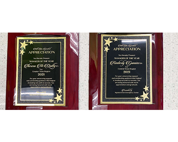 Two plaques with gold stars on them are sitting on a table.