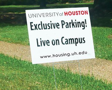 A sign that says university of houston exclusive parking live on campus