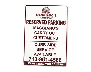 A reserved parking sign for maggiano 's little italy