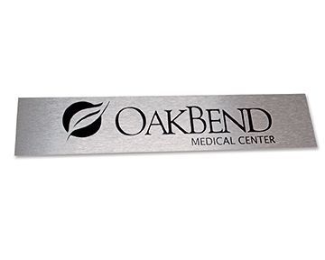 A stainless steel sign for oakbend medical center on a white background.