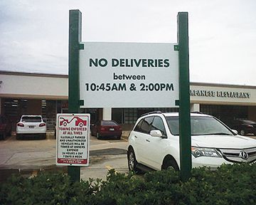 A sign that says no deliveries between 10:45 am and 2:00 pm