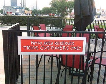 A sign that says patio area reserved for trios customer only
