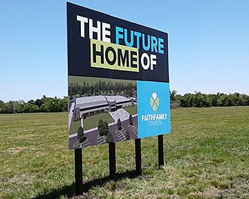 A billboard in a field that says `` the future home of ''.