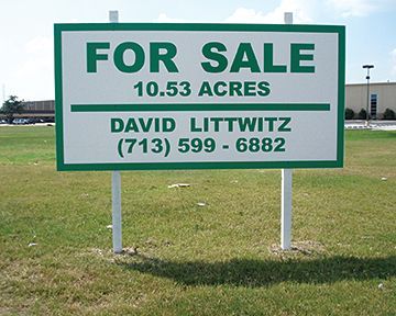 A green and white sign that says for sale 10.53 acres