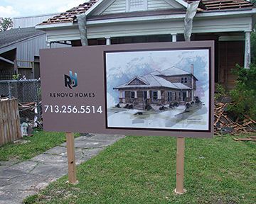 A sign for renovo homes is in front of a house
