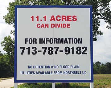 A sign that says ' 11.1 acres can divide ' on it