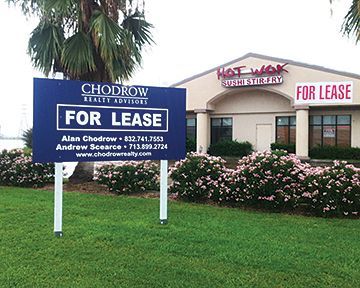 A for lease sign in front of a hot wok restaurant
