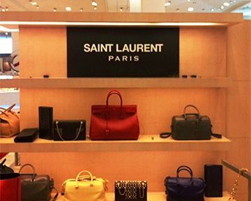 A display of saint laurent paris bags in a store