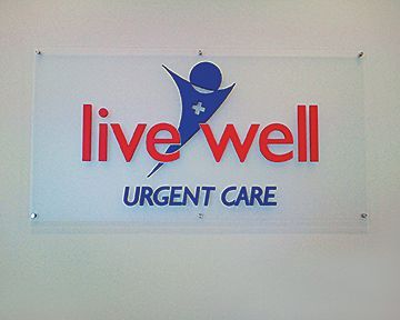 A sign that says live well urgent care on it