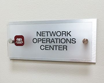 A sign on a wall that says `` network operations center ''.