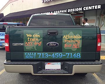 A ford truck is parked in front of a graphic design center