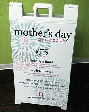 A sign that says mother 's day spa specials on it